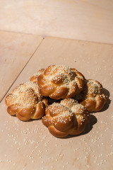 Buns with sesame seeds on a wooden background