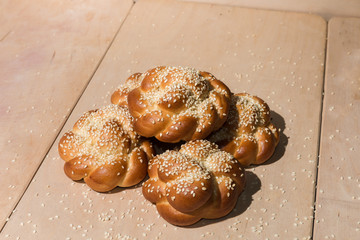 Buns with sesame seeds on a wooden background