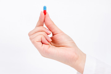 hand of nurse doctor holding blue and red capsule4