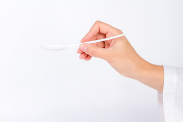 hand of nurse doctor stretches empty spoon