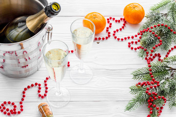 Obraz na płótnie Canvas New Year 2018 background. Champagne in bucket, glasses with beverage, tangerines and decoration on grey background copyspace