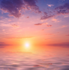 A magnificent sunset with a bright sun over the sea.