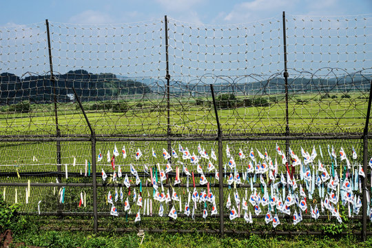 South korean flags and ribbons at a fence at the green demilitarised zone DMZ at the freedom bridge, South Korea, Asia