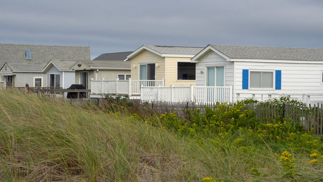 Generic Ocean Front Beach House Condo View Day Time Exterior. Luxury Real Estate Along Sand Dunes For Summer Home Vacation Location