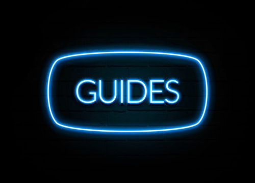Guides  - colorful Neon Sign on brickwall