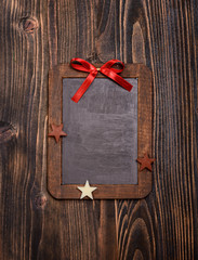 Vintage empty chalkboard with christmas decoration and on wooden background