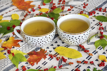 Autumn fall leaves and two cups of tee.Morning time.Still life concept.