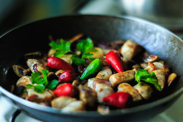 chicken pieces frying in the pan or wog