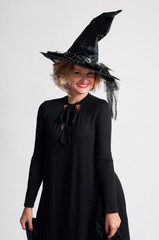 Happy woman in witch halloween costume with hat