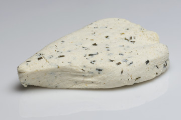Homemade white cheese with herbs on white background