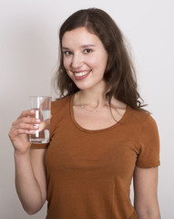 young woman holding a glass of water