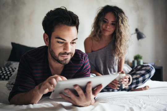 Couple Using a Tablet in Bed in the Morning