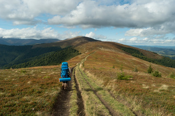 tourist with a backpack walks along the ridge.