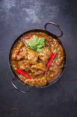 Traditional Indian curry lamb masala as close-up in a Korai