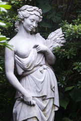 Sculpture of woman in tropical garden, art expression in exterior guatemala.