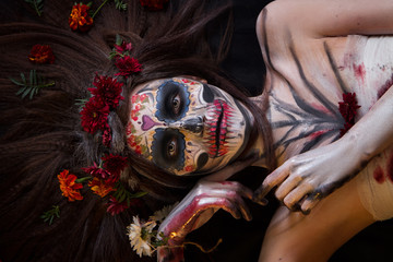 Beautiful girl with scary Halloween make-up