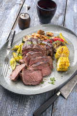 Barbecue wagyu chateaubriand with vegetable and maize as close-up on a plate