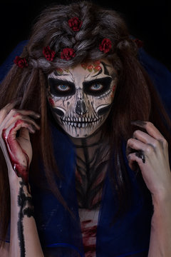 Beautiful girl with scary Halloween make-up