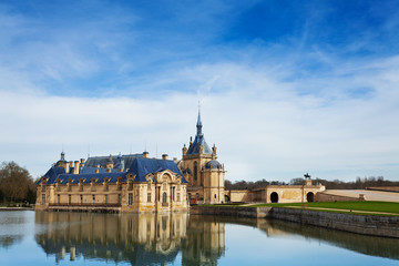 Mirror surface lake reflecting Chantilly castle - obrazy, fototapety, plakaty
