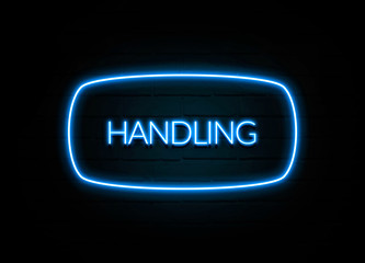 Handling  - colorful Neon Sign on brickwall