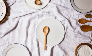 Empty plates on a table Close up of empty plates on a linen towel white table