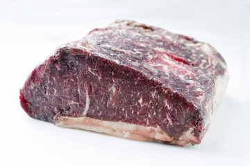 Raw dry aged Kobe roast beef as close-up – covered