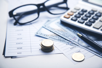 money, calculator and glasses on the document