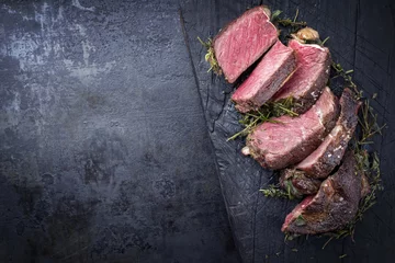 Zelfklevend Fotobehang Barbecue dry aged Kobe rib eye steak as close-up on a burnt board with copy space left © HLPhoto