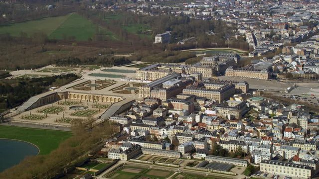  Aerial view above the palace of Versailles with landscaped gardens