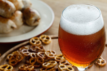 Beer glass with german pretzel and sausage