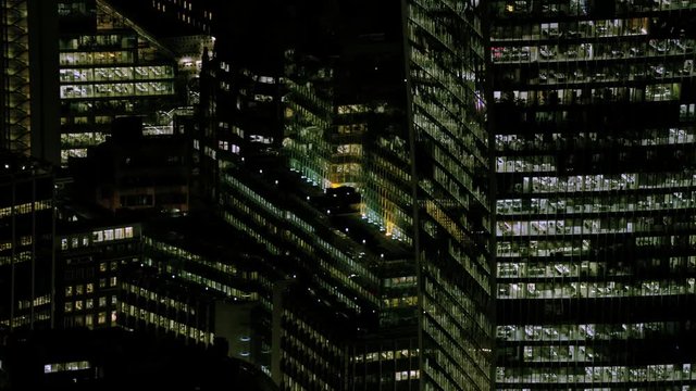 Aerial view of London business skyscrapers, city offices illuminated at night