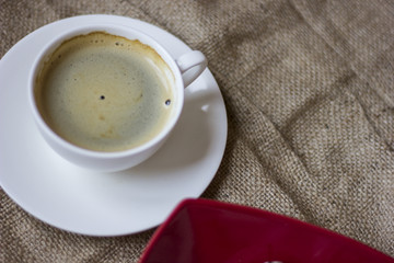 hot cup of coffee with couple of heart shaped chocolate cookies.