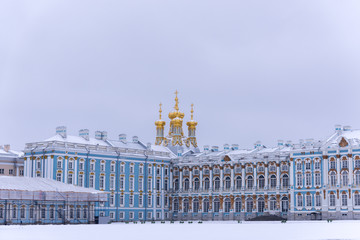 Fragment of the facade of the Catherine Palace with the domes of the Resurrection Church on a dull...