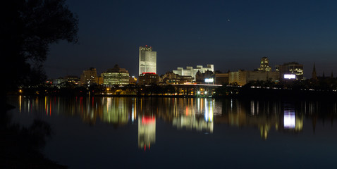 Fototapeta na wymiar City of Albany lights and reflections on the Hudson River looking from the Renssalear docks in NY