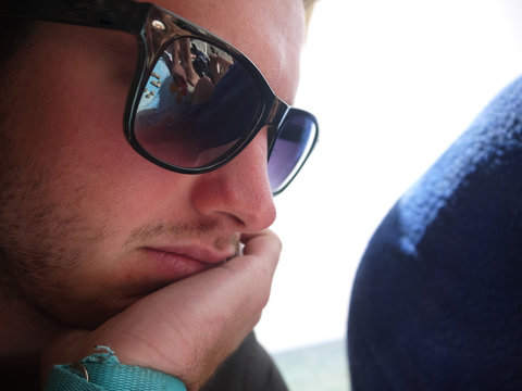 Young man thinking during scrabble game