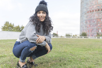 portrait of a woman with wool cap and sweater in park