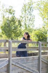 Portrait of a sensual woman on a wooden bridge