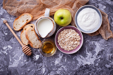 Oat, milk, yogurt, bread and apple. 