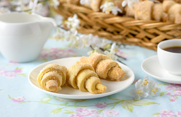 Many croissants on a table with spring flowers