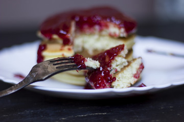 A perfect breakfast combo of jam, pancakes, and a hot cup of coffee.