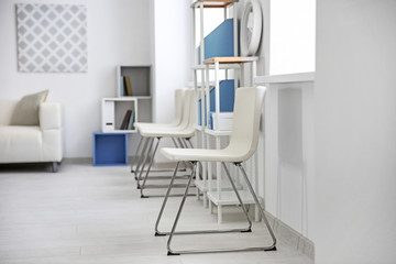 Fototapeta premium Modern room interior with white chairs and shelving unit