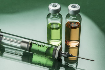 Medicine vials and syringe, conceptual image