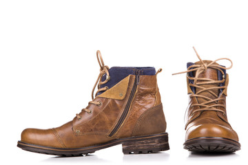 a pair of worn boots isolated on a white background