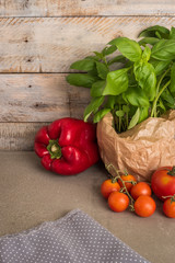 Fresh basil and other ingredients for Italian cuisine. Cherry tomatoes, basil and red pepper