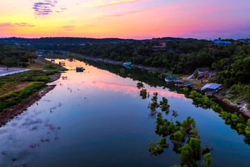 The sun rises behind the Pedernales River in the Texas hill country