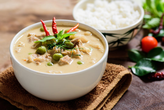 Thai food (Panaeng curry),red curry with pork and cooked rice in a bowl on wooden background