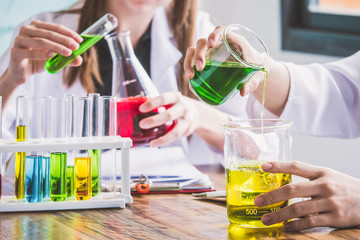 Couple of students working at chemistry class. Education concept