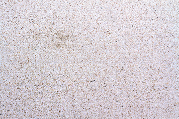 Light concrete structure walls interspersed with small stones