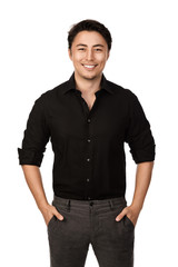 Fototapeta premium Attractive man in a black shirt and grey pants, standing with a big smile against a white background,