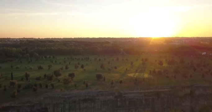 Video from above. Aerial view of the ancient Roman Aqueduct at sunset. Old ruins surrounded by a green public Park (Parco degli Acquedotti) Rome, Italy.